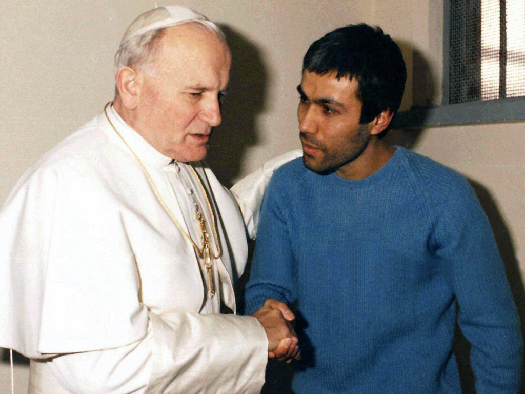 Pope John Paul II meeting Mehmet Ali who tried to kill him previously.